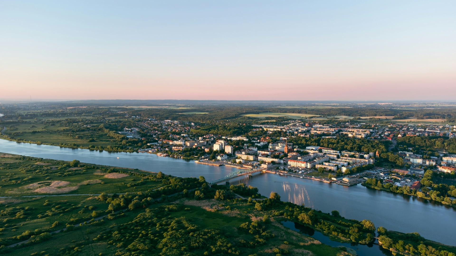 Aerial view of a European city on a river at dawn